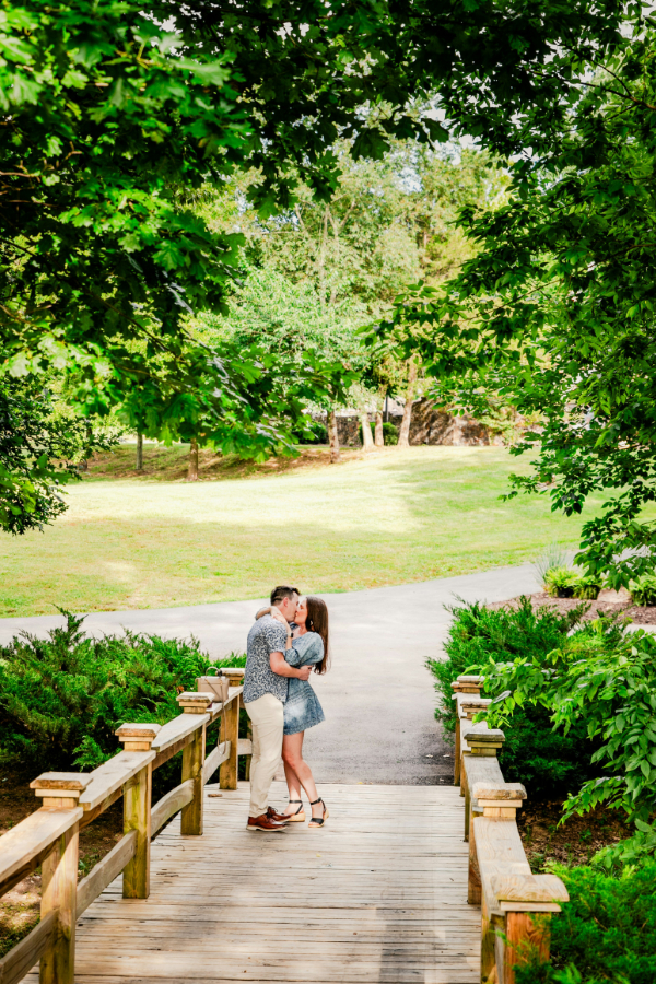 A romantic proposal setup at sunset with a stunning view of Idaho’s landscapes, including a picnic and engagement ring.